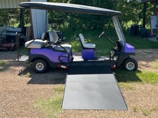 This is a picture of a wheelchair golf cart that displays the wide bariatric golf cart's ramp and other aspects to assess the needs of someone needed a wheelchair accessible or handicap accessible golf cart.