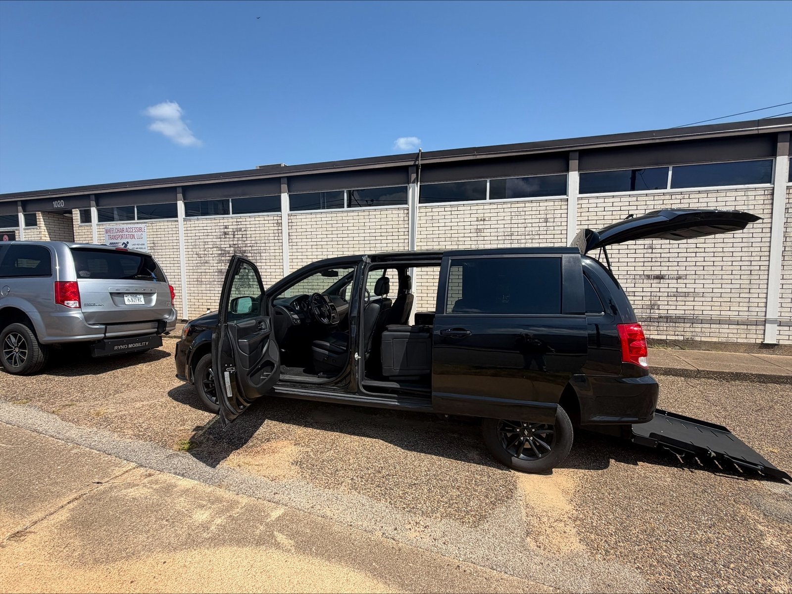 Wheelchair Van Rental 8473 Side Profile of Driver Side with Rear Entry Ramp Deployed View